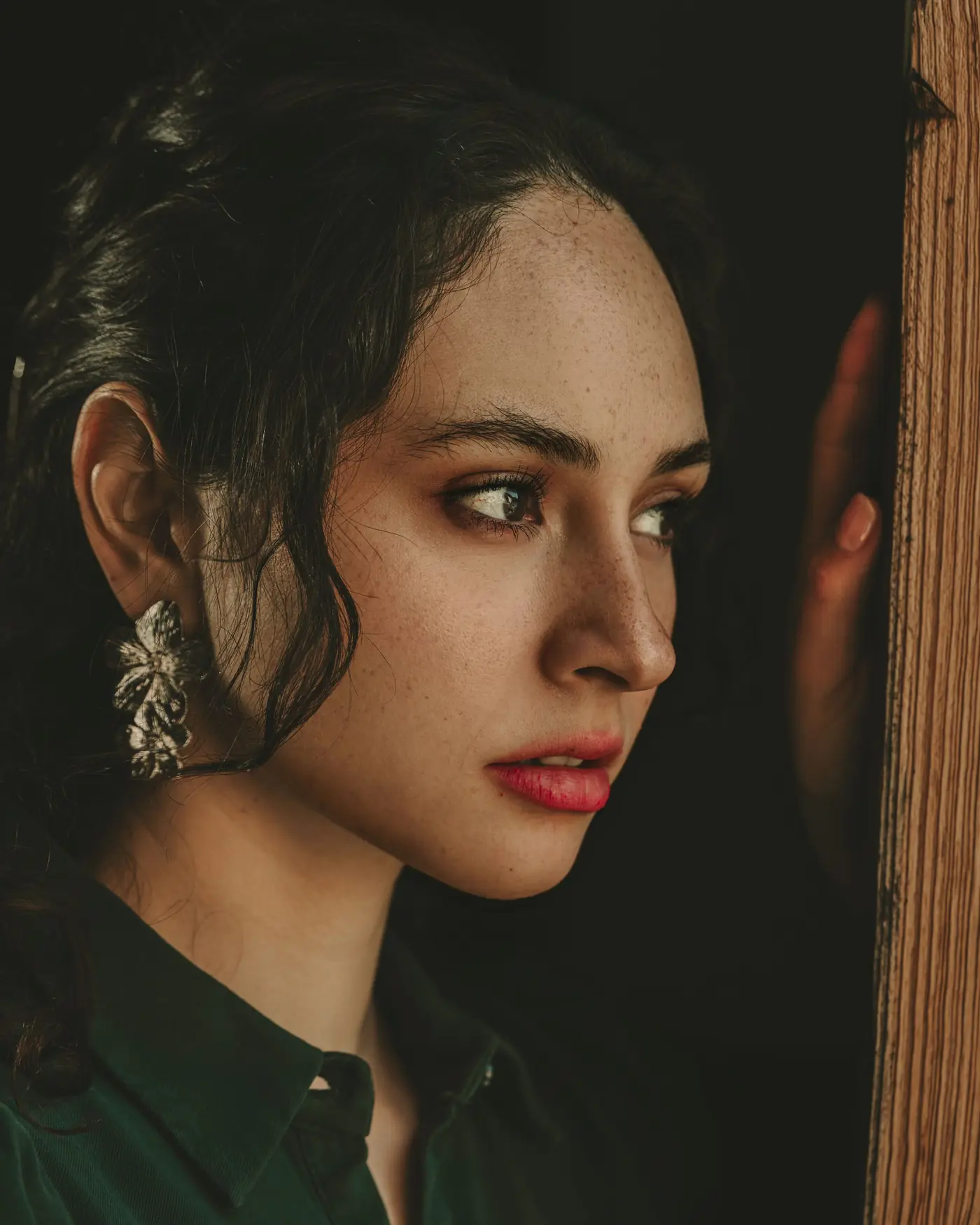 Portrait of a woman with dark hair and statement earrings