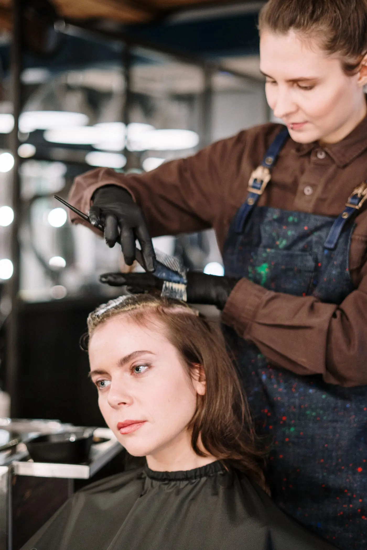 Colourist applying colour at a client’s roots