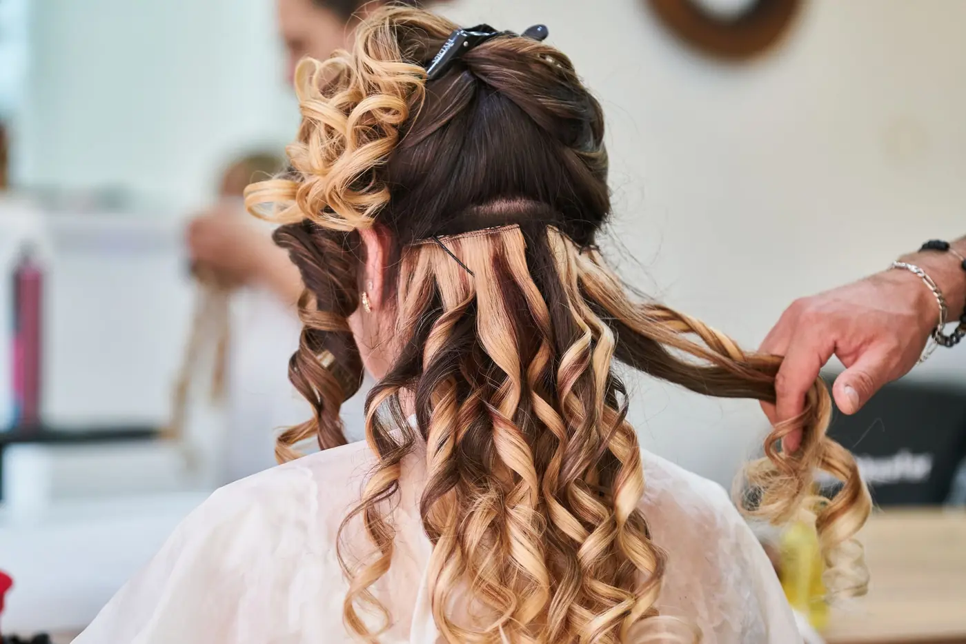 Copper balayage being curled with a tong