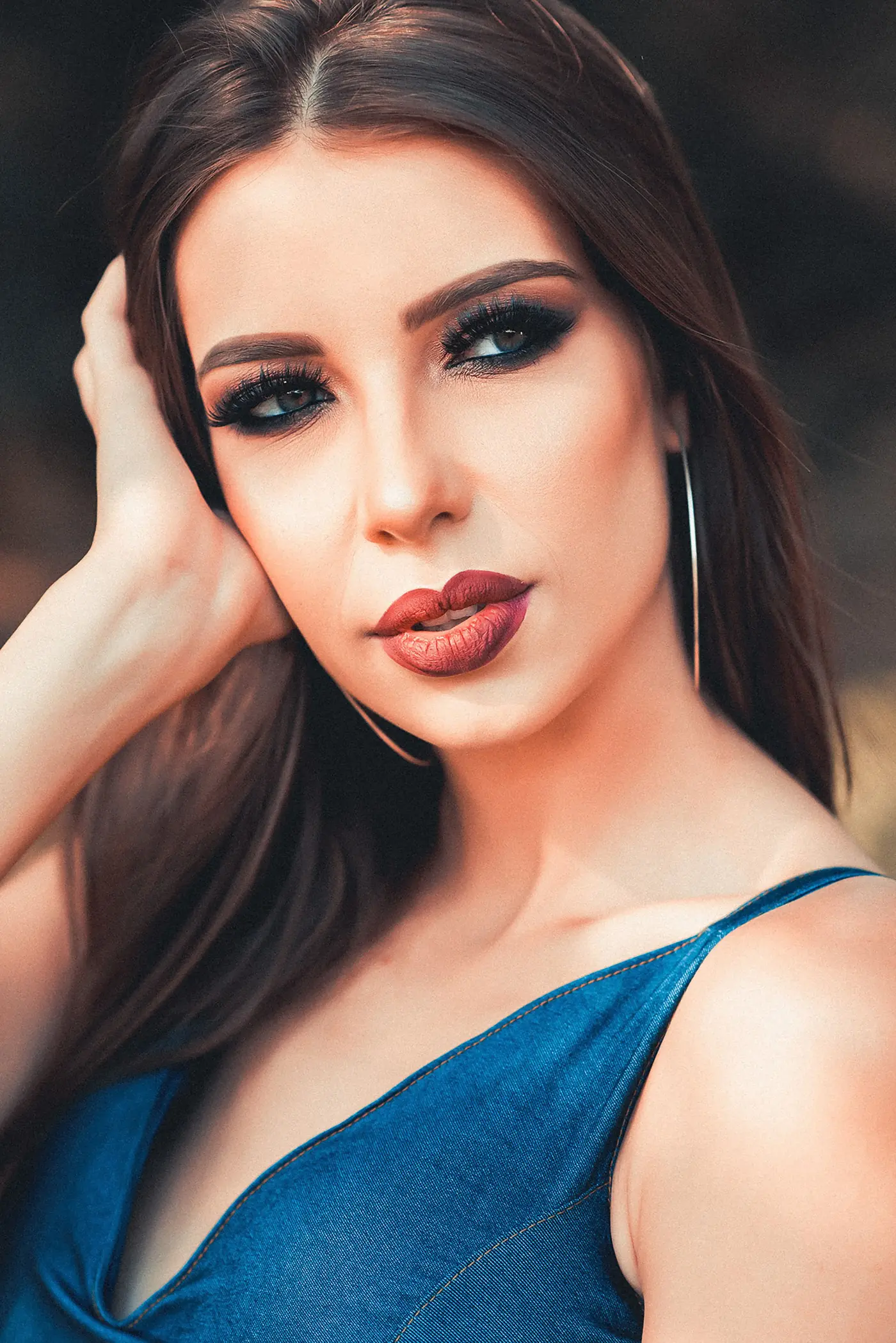Woman with glossy brunette hair and soft glam makeup