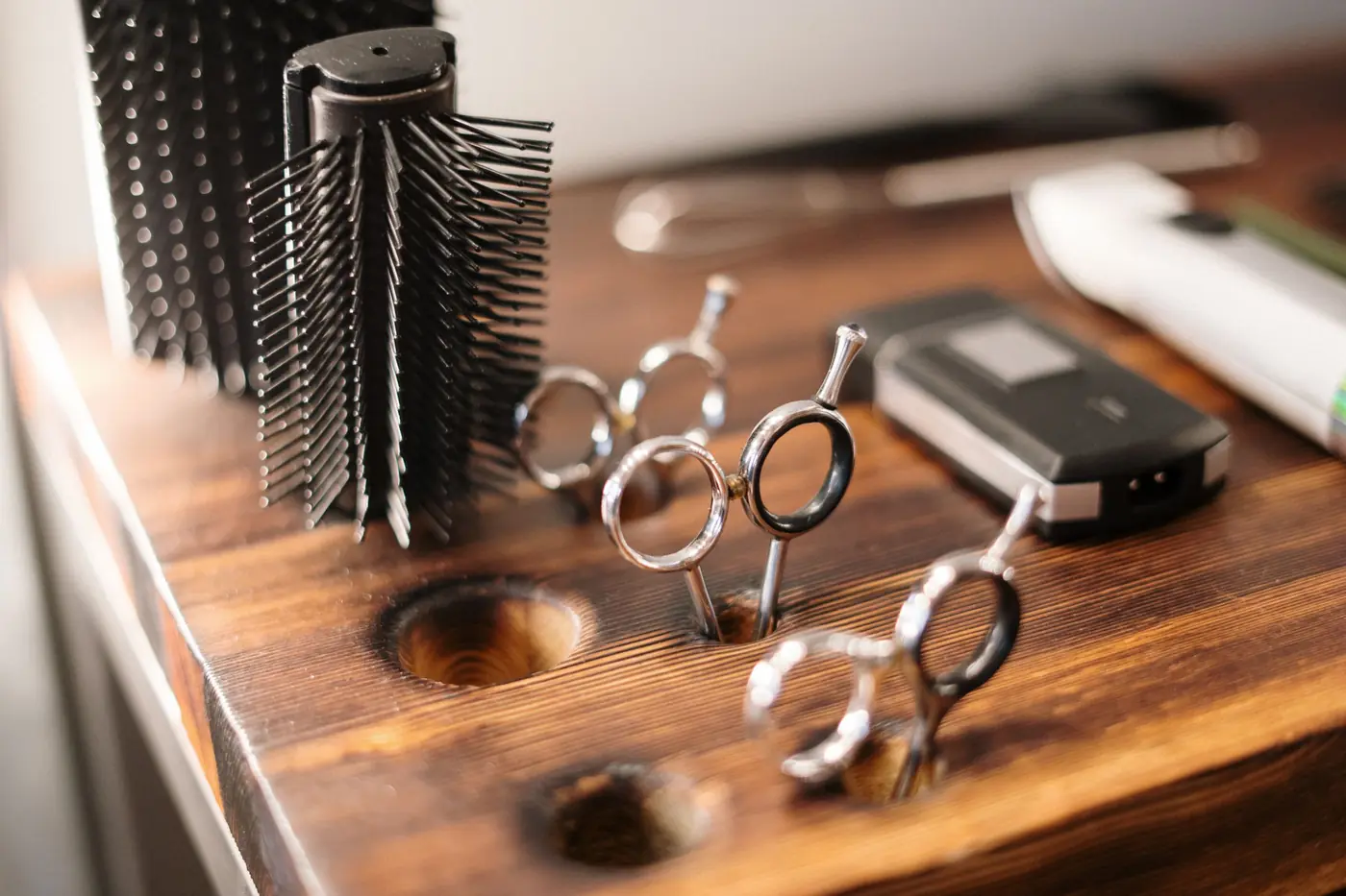 Styling tools laid out on a walnut counter