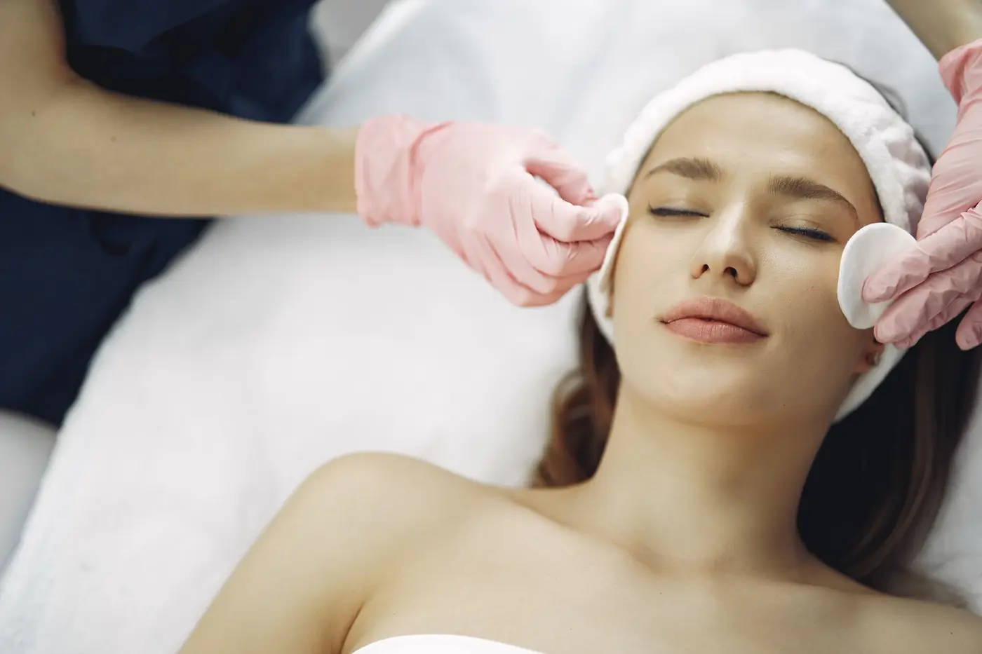 Client relaxing during a facial treatment